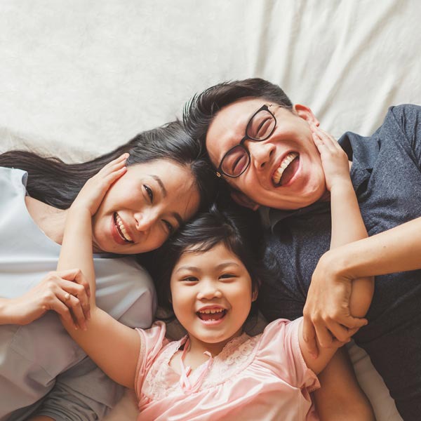 family of three laughing together